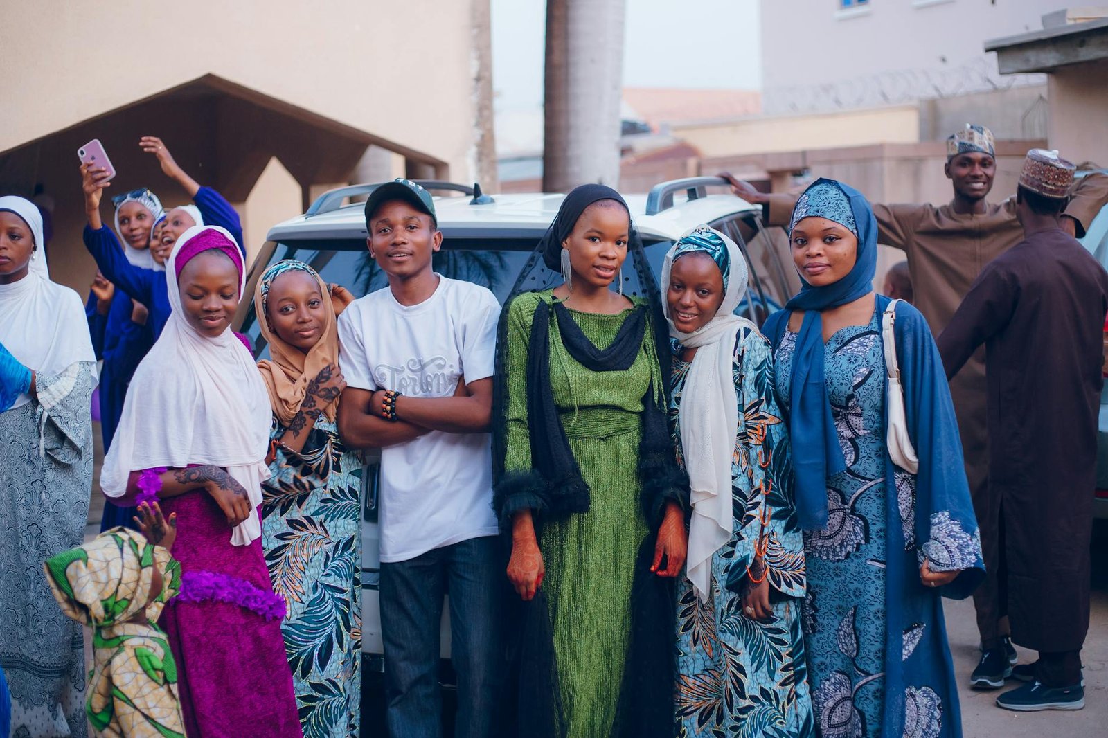 celebrity fashion moments - A vibrant outdoor gathering of adults in colorful traditional attire, capturing cultural expressions.