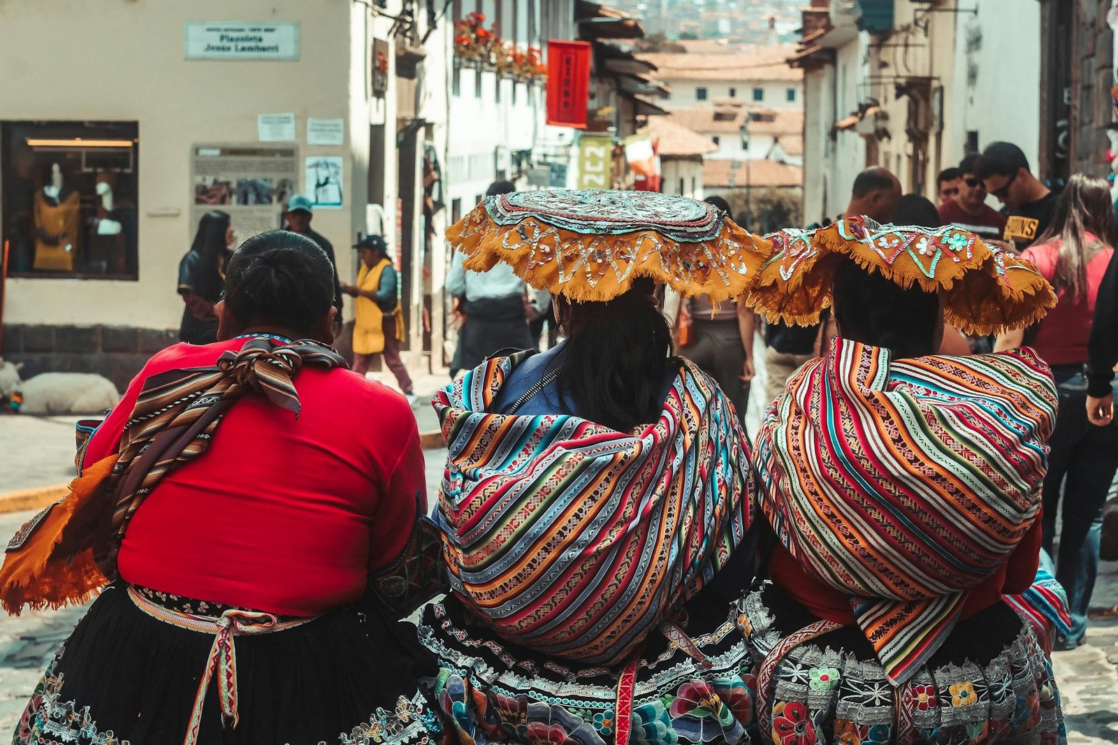 fashion culture and society - Women in vibrant traditional dresses in the streets of Cusco, Peru, showcasing cultural heritage.
