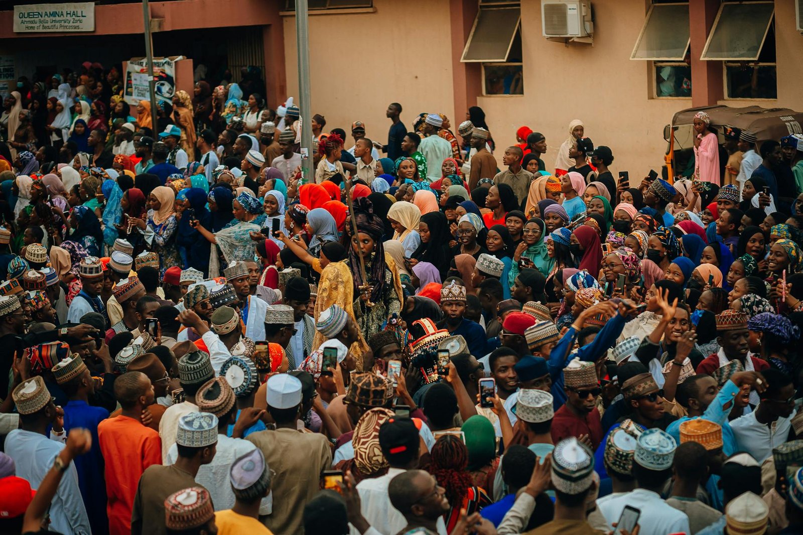 fashion culture and society - A lively crowd of diverse people celebrating at a cultural festival outdoors.