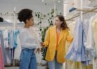 fashion trends and career advice - Two women in a boutique store browsing clothes, discussing styles.