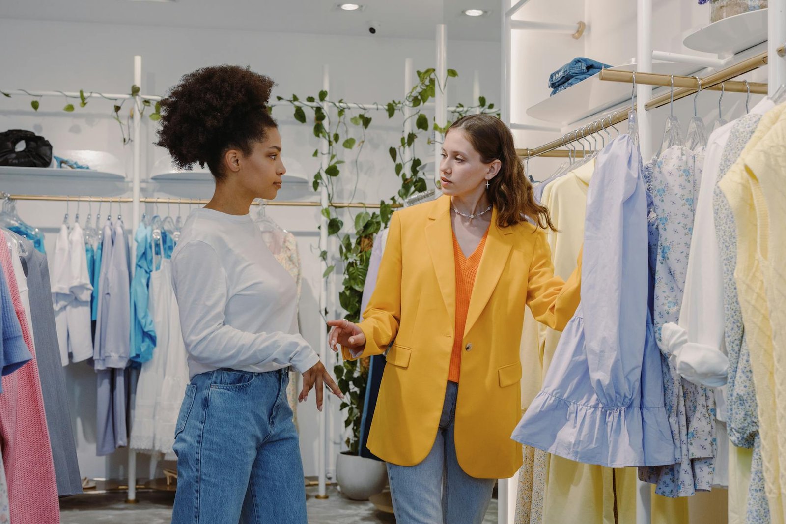 fashion trends and career advice - Two women in a boutique store browsing clothes, discussing styles.