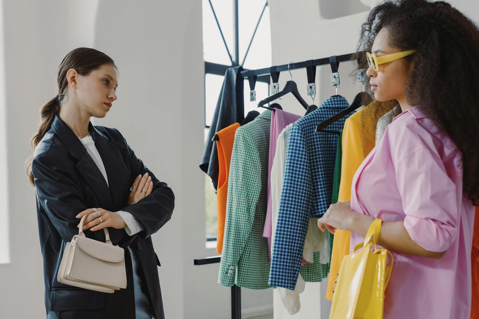 fashion trends and career advice - Two women browsing colorful clothing racks in a modern boutique.