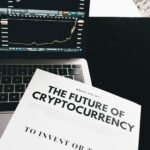 how to invest in crypto - A detailed look at cryptocurrency market trends using a laptop and analytical document.