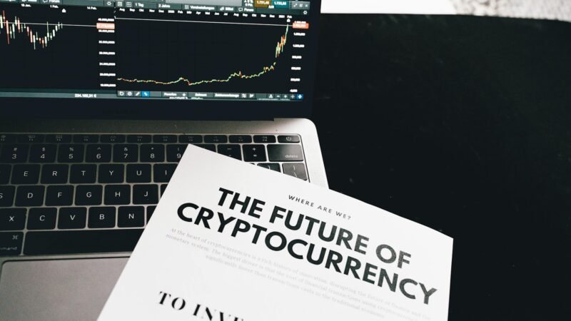 how to invest in crypto - A detailed look at cryptocurrency market trends using a laptop and analytical document.