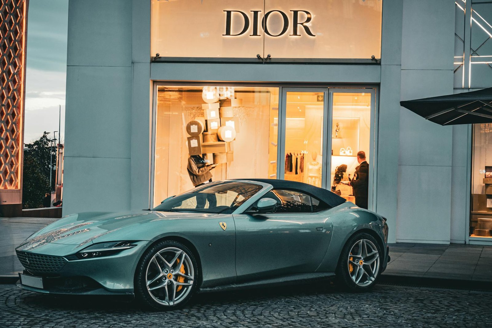 luxury lifestyle fashion trends - A sleek Ferrari parked in front of a Dior store in Istanbul, capturing a blend of luxury and elegance.