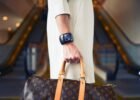 luxury lifestyle fashion trends - Chic woman with luxury handbag and bracelet in modern shopping environment.