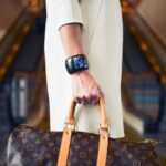 luxury lifestyle fashion trends - Chic woman with luxury handbag and bracelet in modern shopping environment.