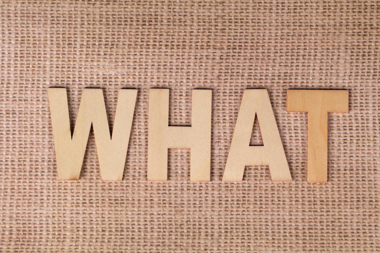 What Is Fintechzoom Image 31984649 what is fintechzoom - Wooden letters forming the word WHAT set on a textured burlap surface.